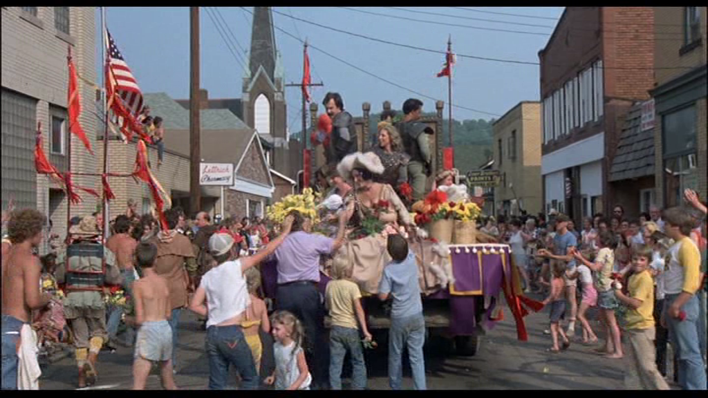 A still from Romero’s Knightriders. In this parade sequence, which takes place in nearby Natrona Heights, PA, the cast of the film is engulfed by and becomes one with the extras from the real world community. Also note the distinctive Appalachian hills ever-present in the background, serving as a constant reminder of the film’s geographic specificity.